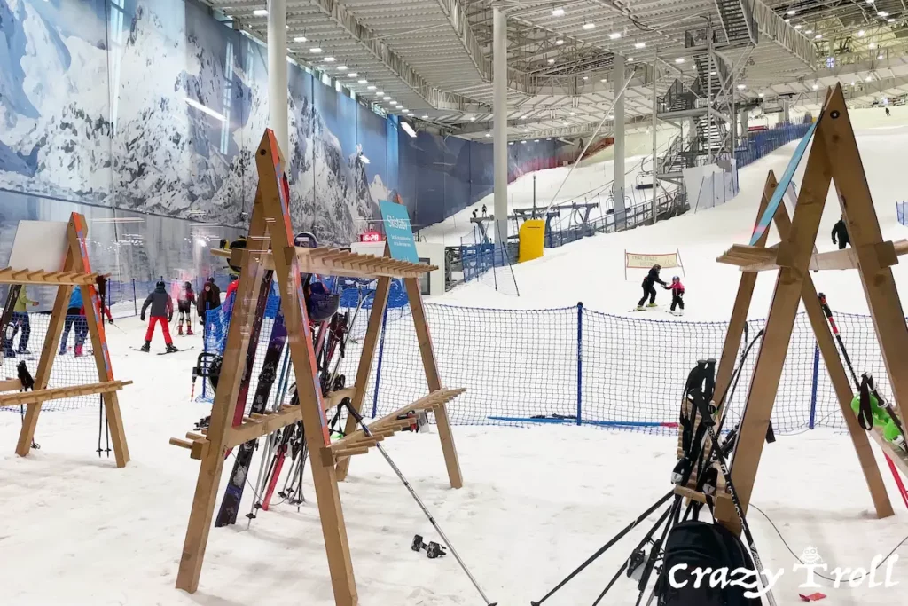 Skiers and snowboarders enjoying the indoor slopes at SNØ in Oslo, Norway, with well-lit trails and a controlled snowy environment.